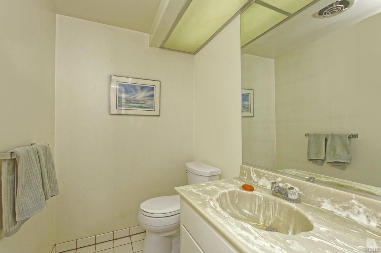 5414 Parkmor Road Calabasas, CA 91302 - Photo 36 of 58 a bathroom with a granite countertop sink toilet and a mirror