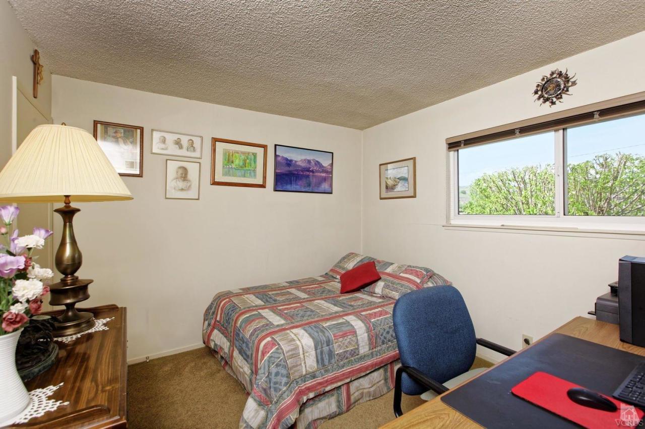 5414 Parkmor Road Calabasas, CA 91302 - Photo 37 of 58 a bedroom with a bed and a lamp on the table