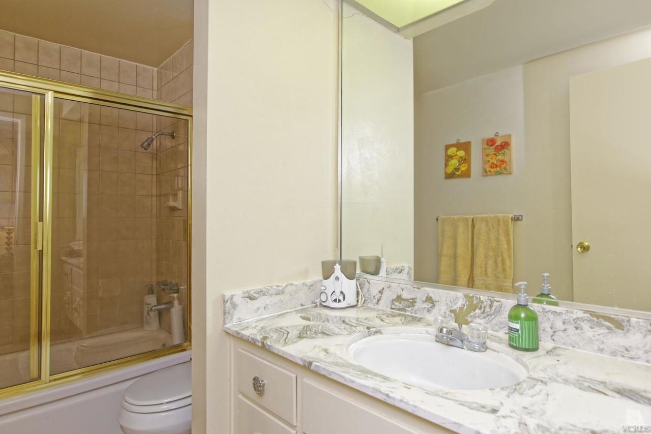 5414 Parkmor Road Calabasas, CA 91302 - Photo 40 of 58 a bathroom with a granite countertop sink toilet and shower