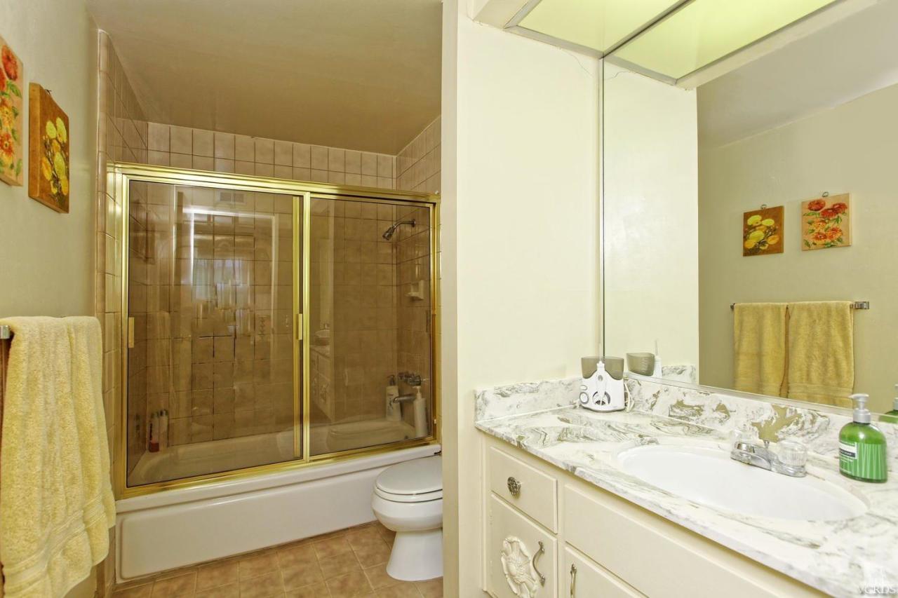 5414 Parkmor Road Calabasas, CA 91302 - Photo 41 of 58 a bathroom with a granite countertop sink toilet and shower