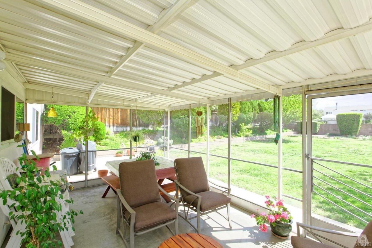 5414 Parkmor Road Calabasas, CA 91302 - Photo 45 of 58 a view of a patio with table and chairs potted plants with wooden floor