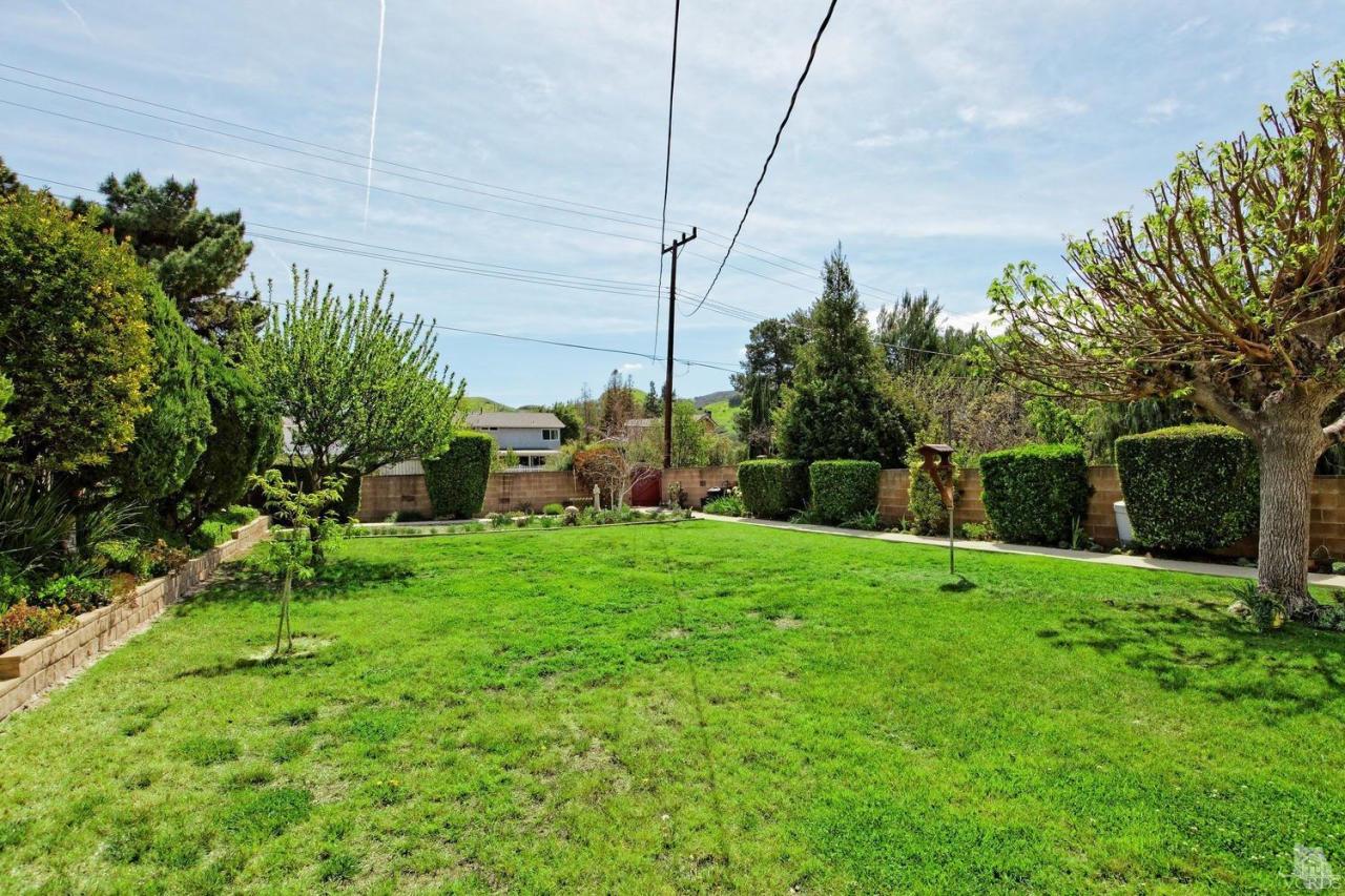 5414 Parkmor Road Calabasas, CA 91302 - Photo 49 of 58 a view of a backyard with plants and a large tree