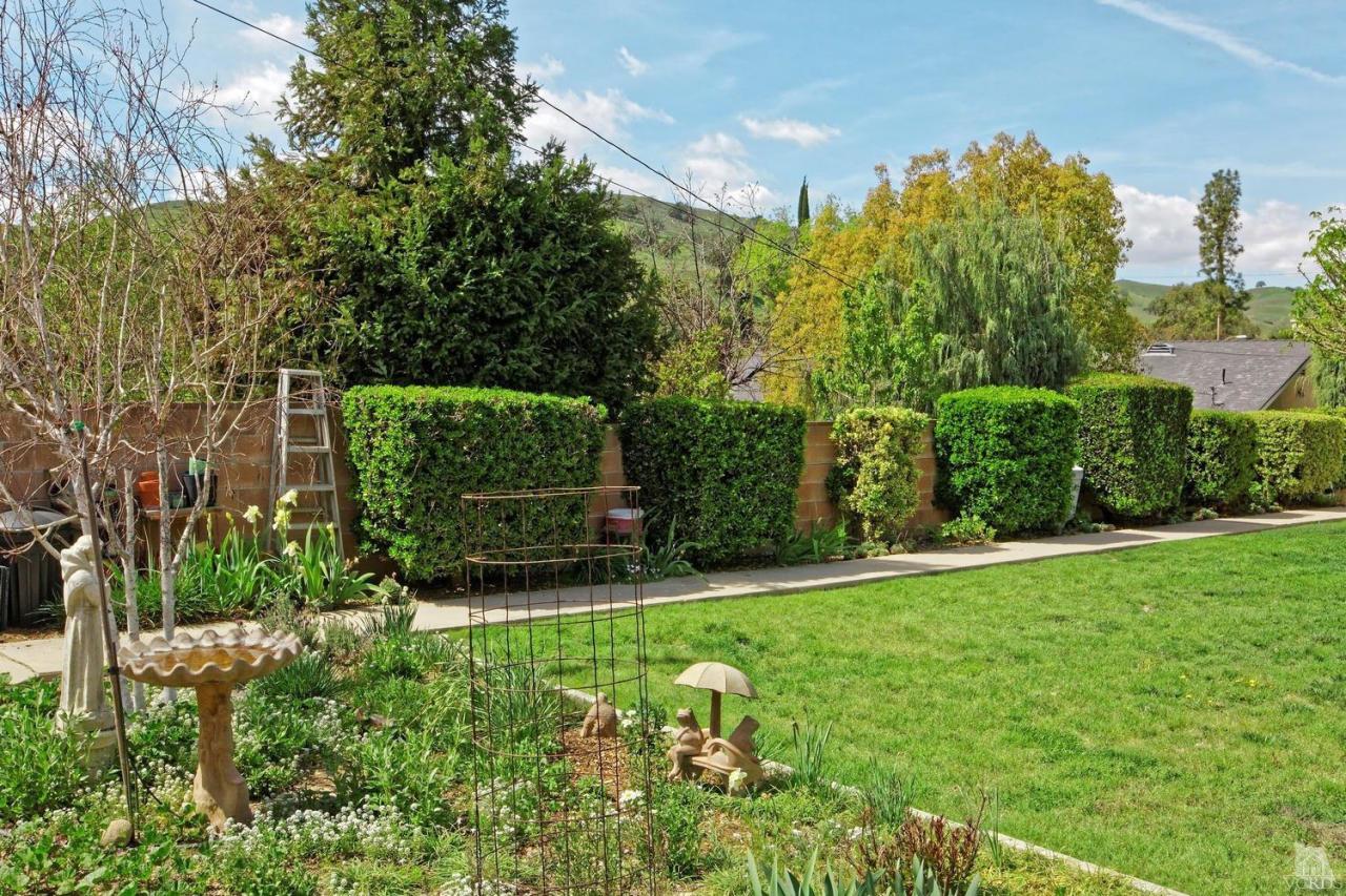 5414 Parkmor Road Calabasas, CA 91302 - Photo 52 of 58 a view of a garden with a bench in the garden
