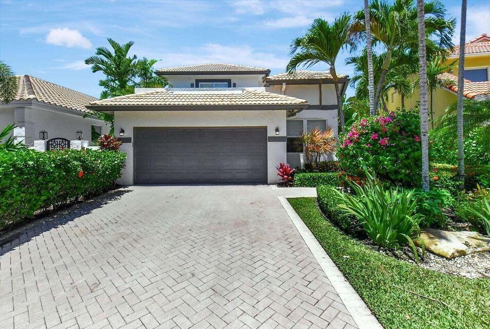 3567 Commodore Circle Delray Beach, FL 33483 - Photo 2 of 76 a front view of a house with a yard and garage