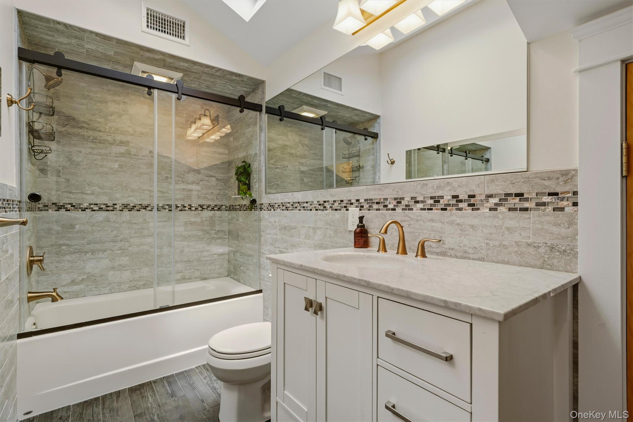 324 Haverstraw Road Suffern, NY 10901 - Photo 22 of 50 a bathroom with a sink a toilet and shower