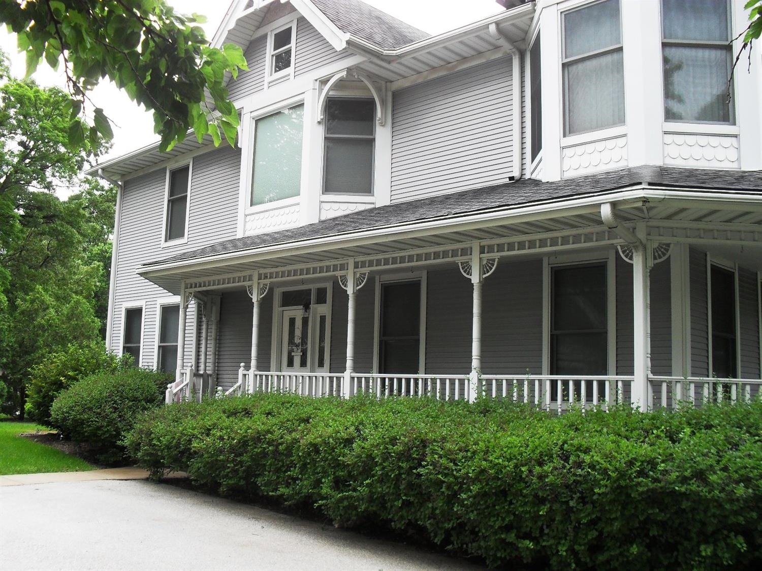 3454 Ridge Road Highland, IN 46322 - Photo 2 of 15 a view of a white house with large windows and a large tree