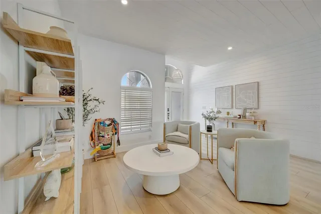 a large bedroom with a bed couches and a flat tv screen