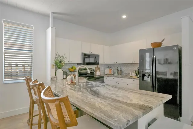 a spacious bedroom with a bed and a table in it