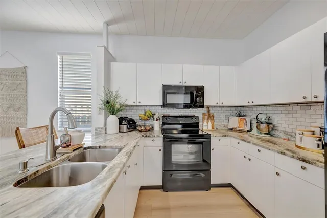 a bathroom with a granite countertop sink a toilet and a mirror