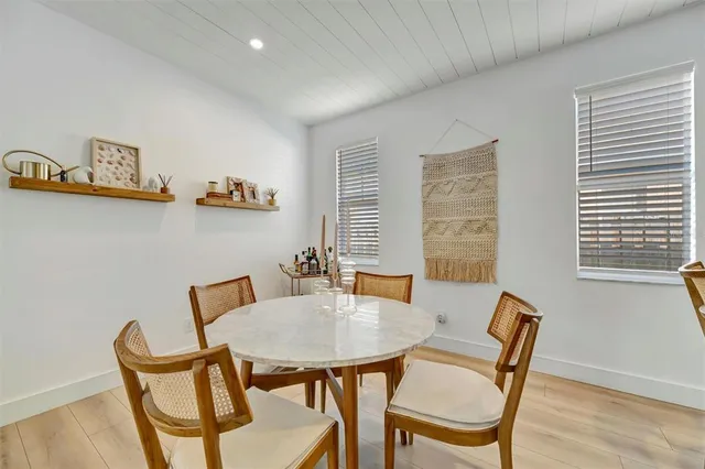 a dining area with a table and chairs