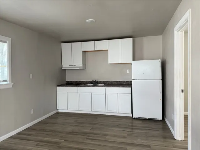 a kitchen with wooden cabinets and white appliances