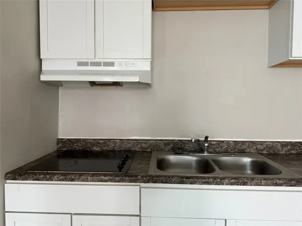 a close view of a sink a counter and a stove