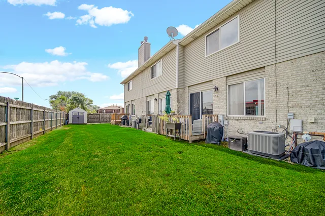 a view of a house with backyard and porch