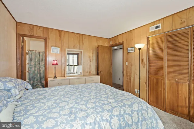 a bedroom with a bed and a dresser