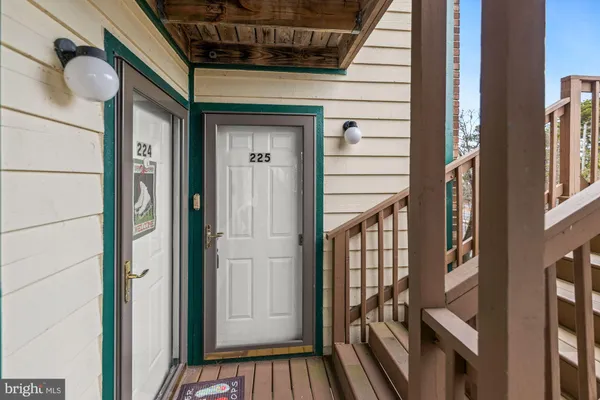 a view of staircase with railing and a chandelier