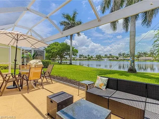 an outdoor sitting area with furniture and garden view