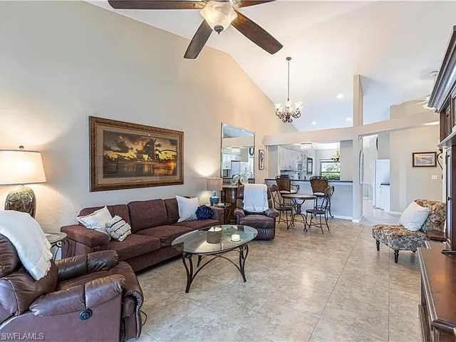 a living room with furniture a rug and a chandelier