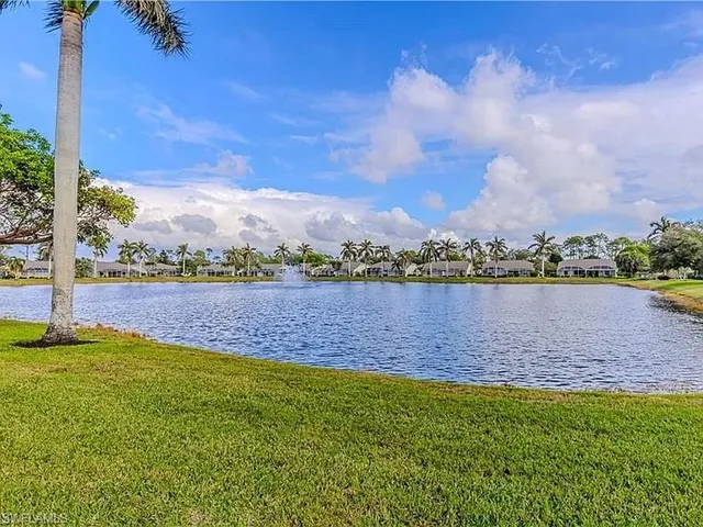 a view of a lake with houses in the background