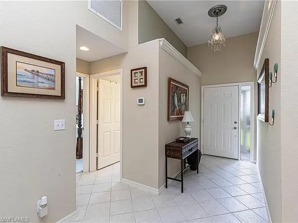 a view of a hallway with stairs and furniture
