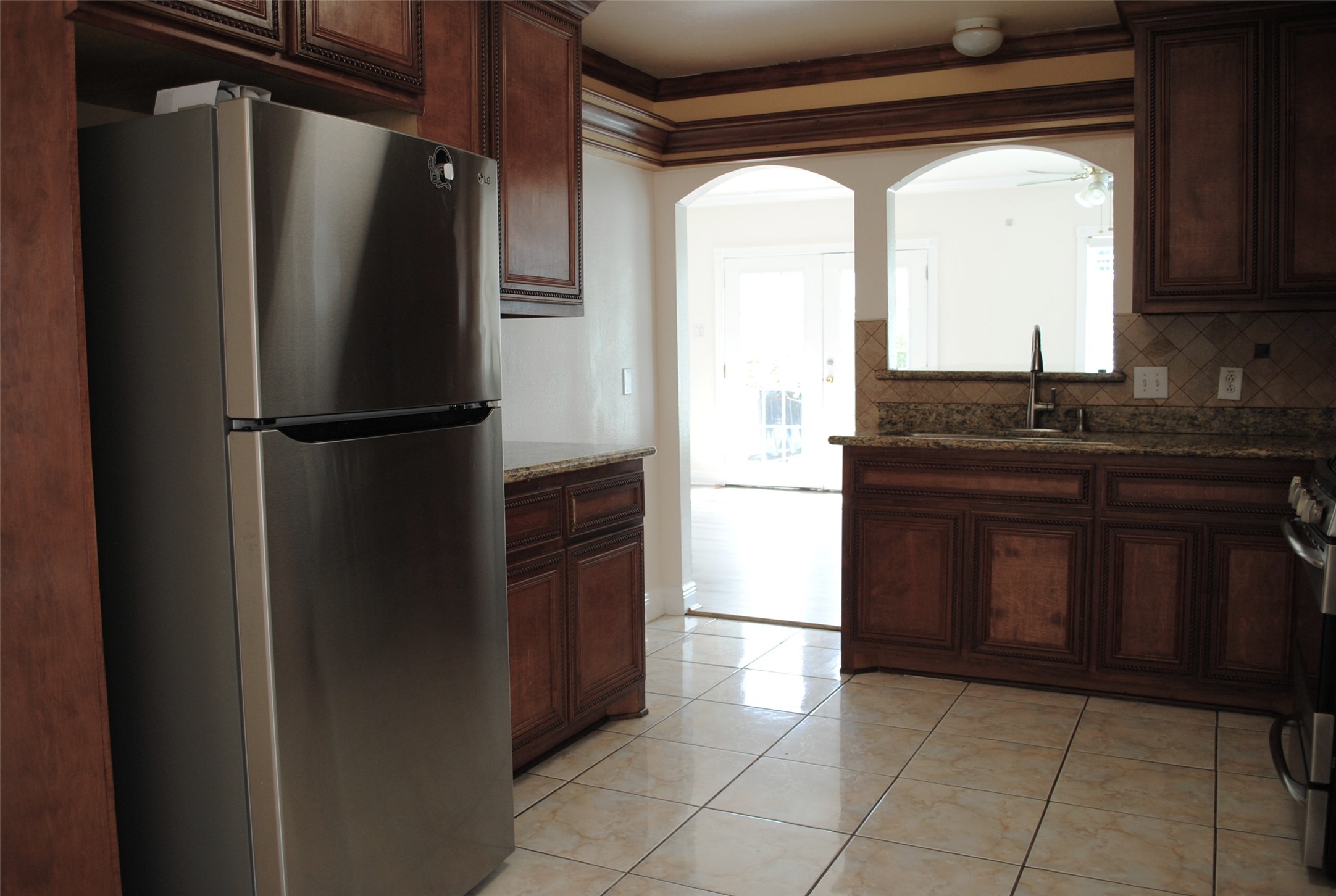 3910 Starbridge Pointe Lane Katy, TX 77449 - Photo 12 of 39 a kitchen with a refrigerator and a sink