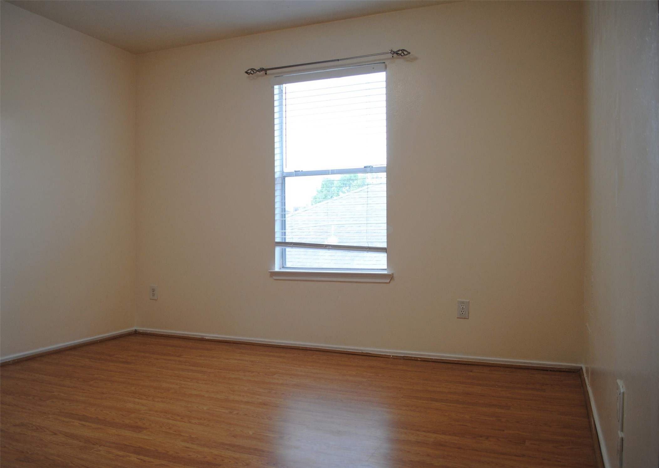 3910 Starbridge Pointe Lane Katy, TX 77449 - Photo 20 of 39 a view of an empty room with wooden floor and a window