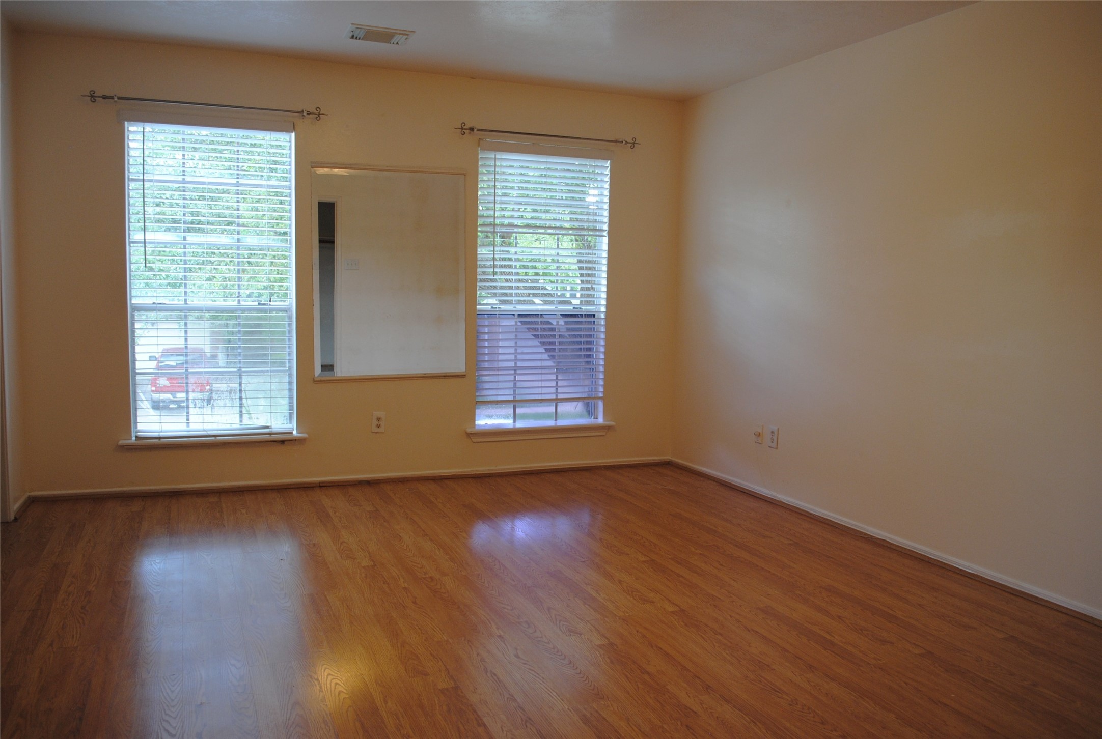 3910 Starbridge Pointe Lane Katy, TX 77449 - Photo 22 of 39 an empty room with wooden floor and windows