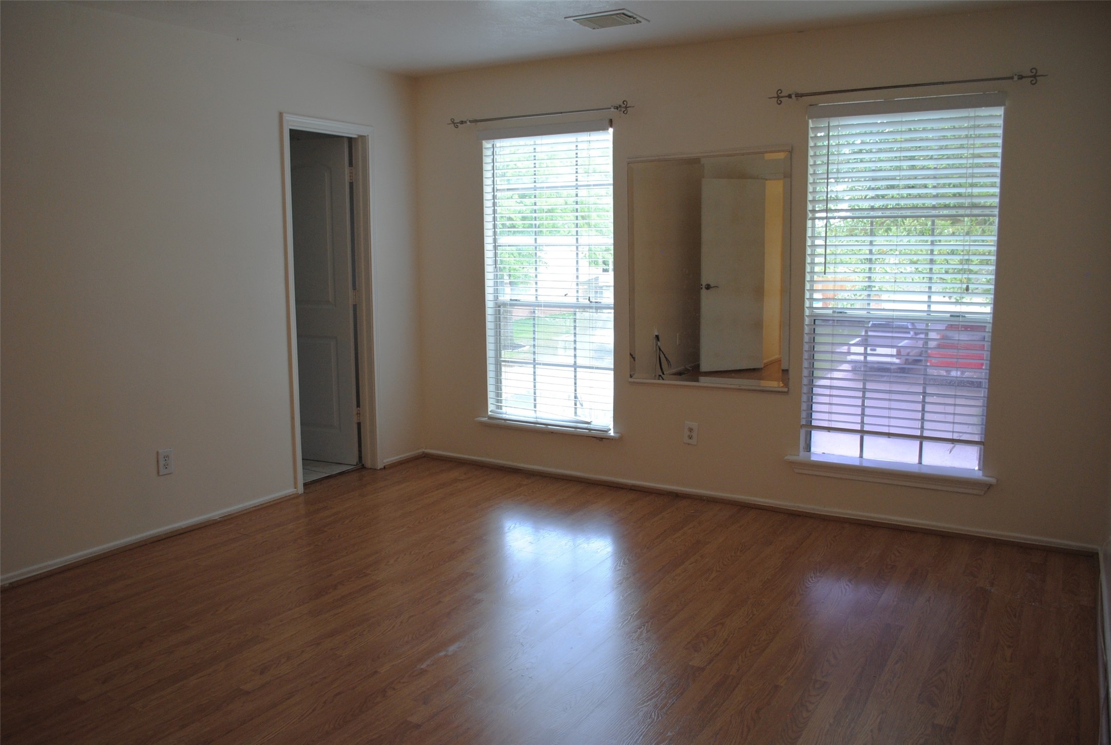 3910 Starbridge Pointe Lane Katy, TX 77449 - Photo 24 of 39 an empty room with wooden floor and windows