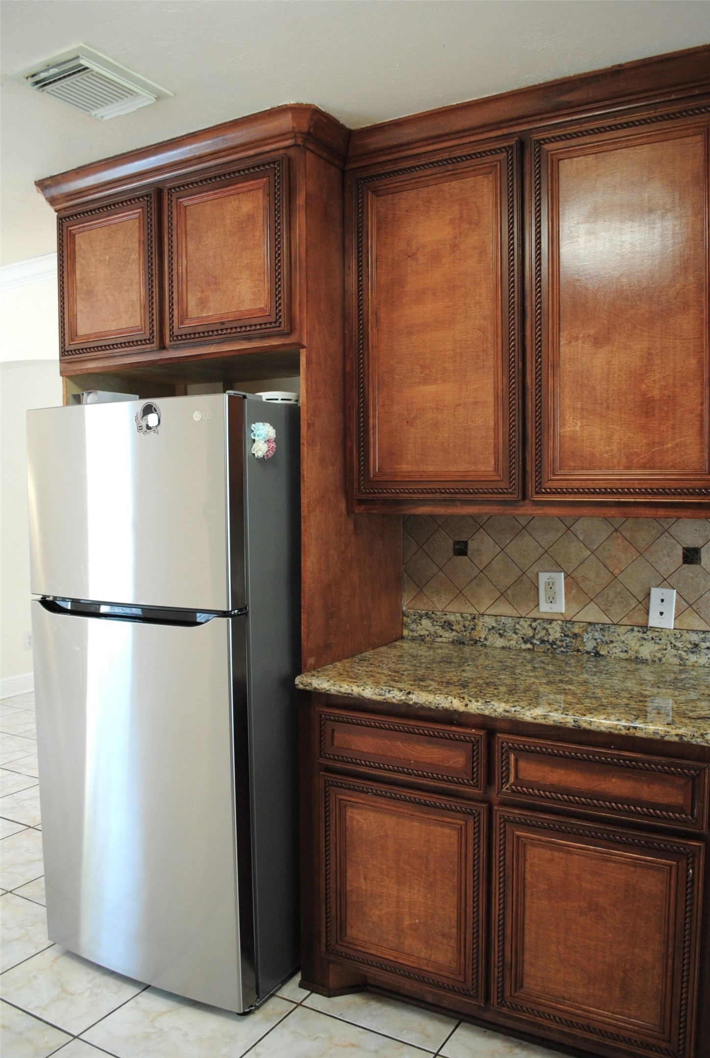 3910 Starbridge Pointe Lane Katy, TX 77449 - Photo 9 of 39 a view of kitchen with a refrigerator and cabinets