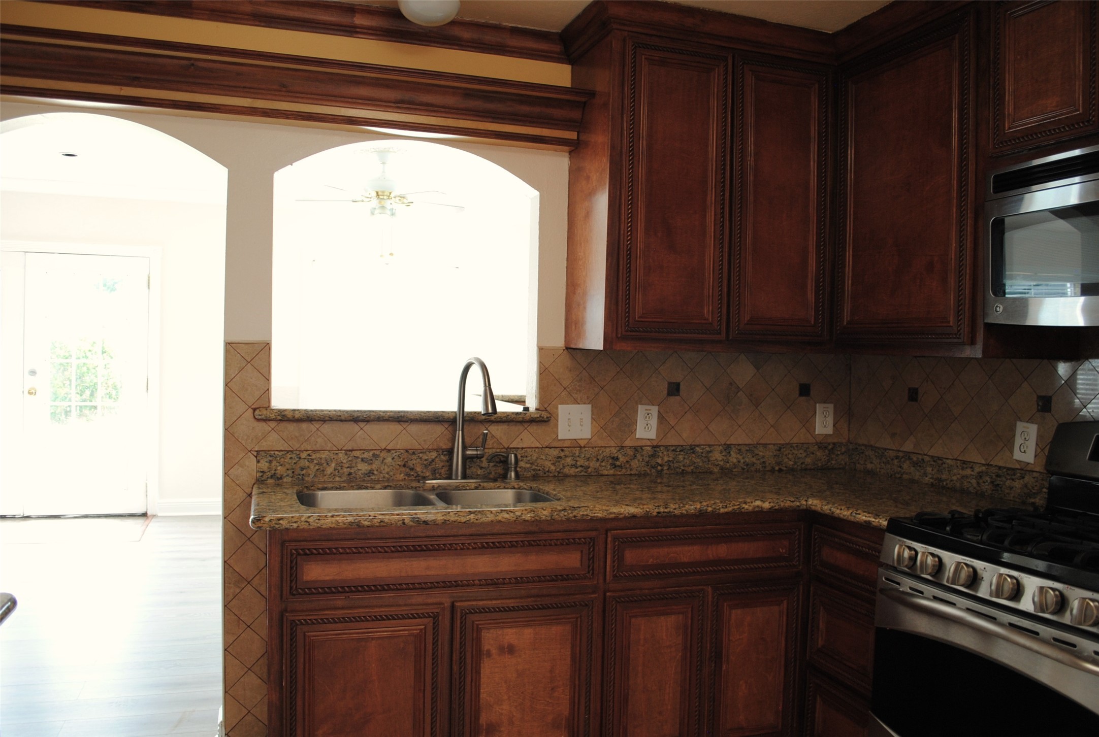 3910 Starbridge Pointe Lane Katy, TX 77449 - Photo 10 of 39 a kitchen with granite countertop a sink and a refrigerator