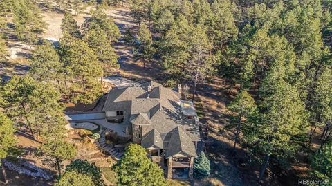 an aerial view of a house with garden space and swimming pool