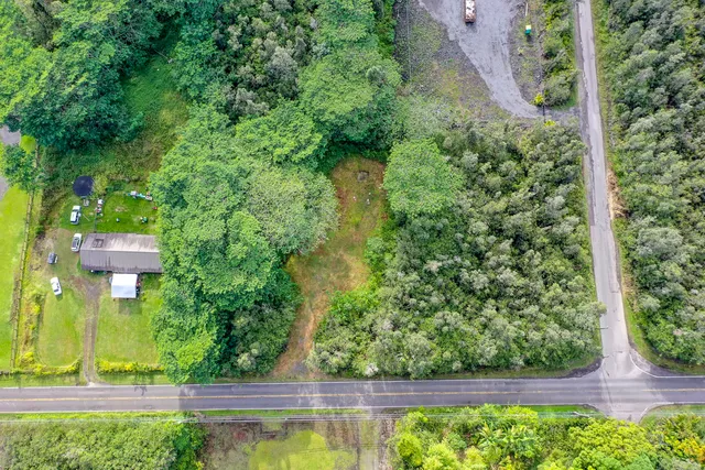 an aerial view of a house with a yard