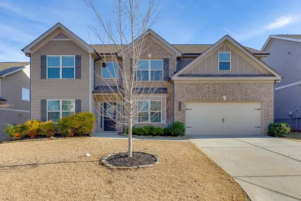 a front view of a house with a yard and garage