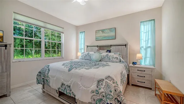 a bedroom with two beds and a painting on the wall