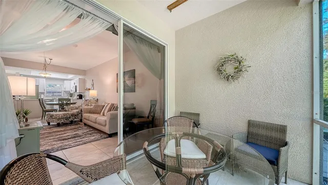 a view of a dining room with furniture and a chandelier