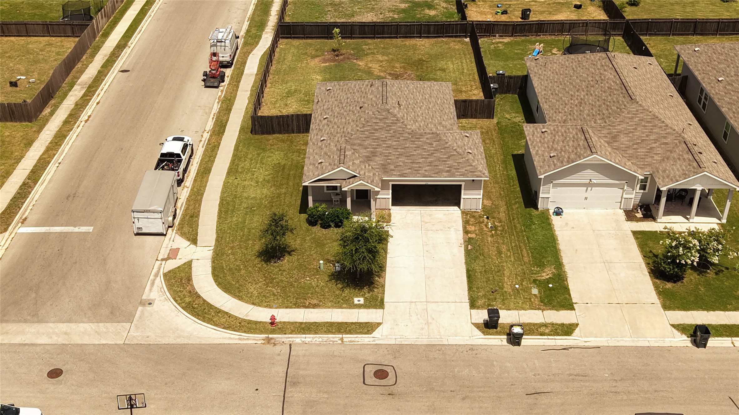 250 Seneca Loop Kyle, TX 78640 - Photo 22 of 22 Aerial view captures a neat suburban home with a spacious driveway and attached garage.