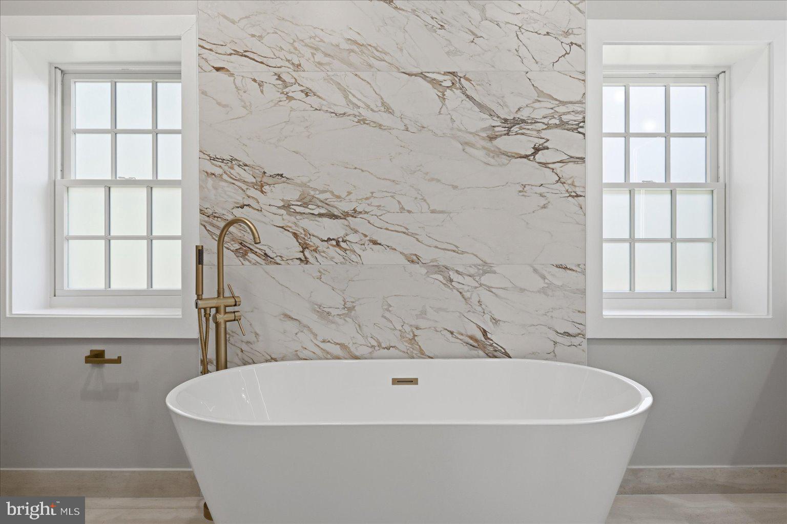 3517 Rodman Street Northwest Washington, DC 20008 - Photo 21 of 57 a white bath tub sitting in a bathroom next to a window