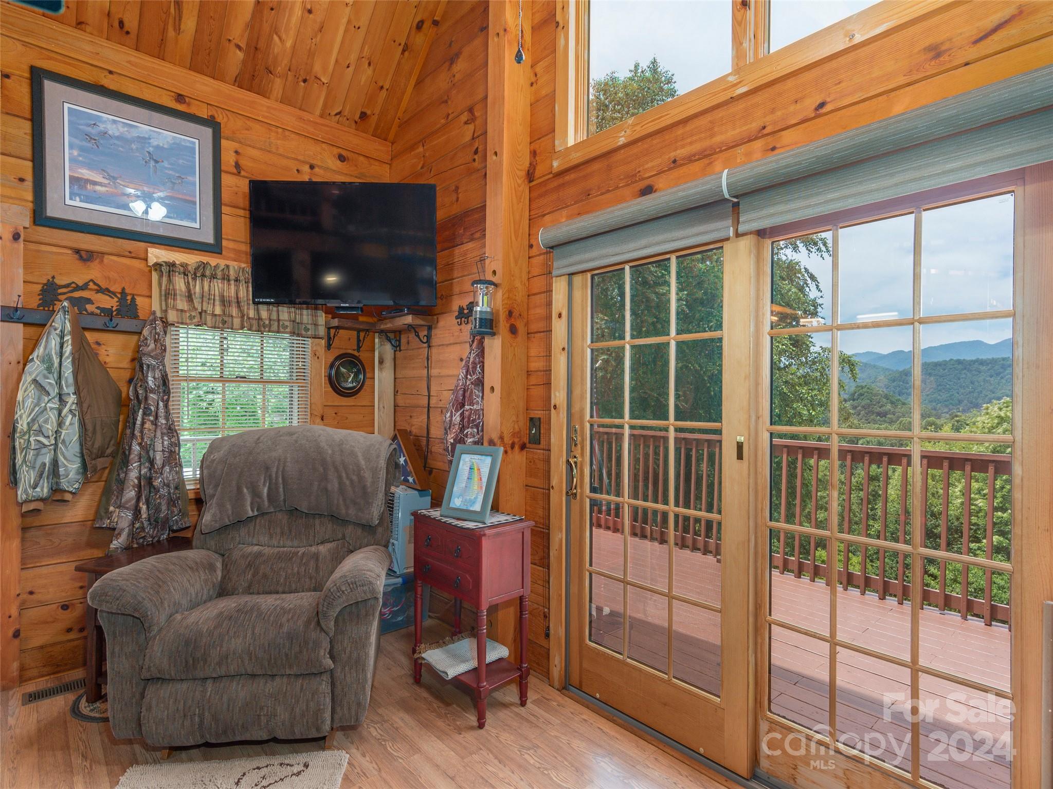 248 Skyview Road Whittier, NC 28789 - Photo 5 of 20 a living room with furniture and a flat screen tv