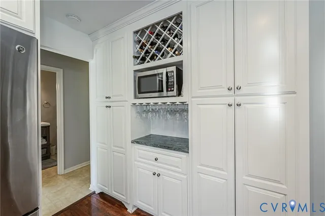 a view of a livingroom with workspace and a window