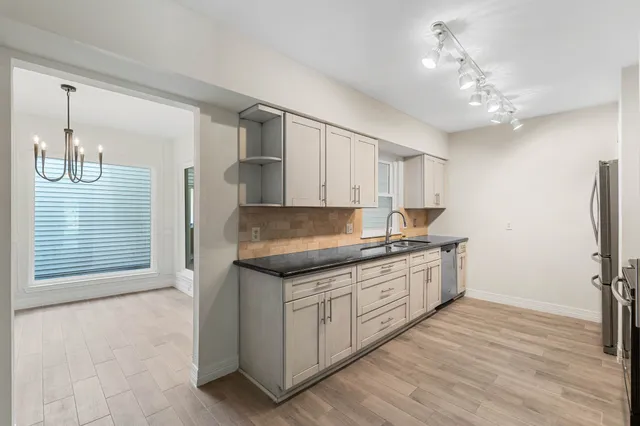 a kitchen with a sink stove and refrigerator