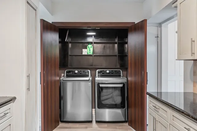 a view of a kitchen with a sink and refrigerator