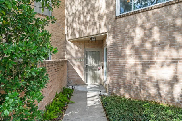 a front view of a house with a yard and fountain in middle