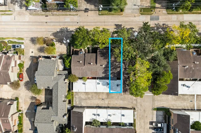 an aerial view of residential houses with outdoor space