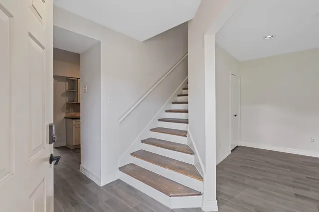 a view of entryway with wooden floor and stairs