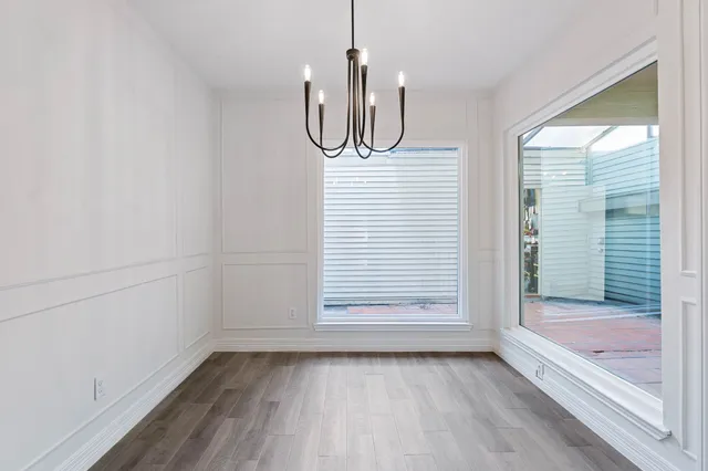 a view of a room with wooden floor and window