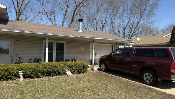 a view of a car parked in front of a house