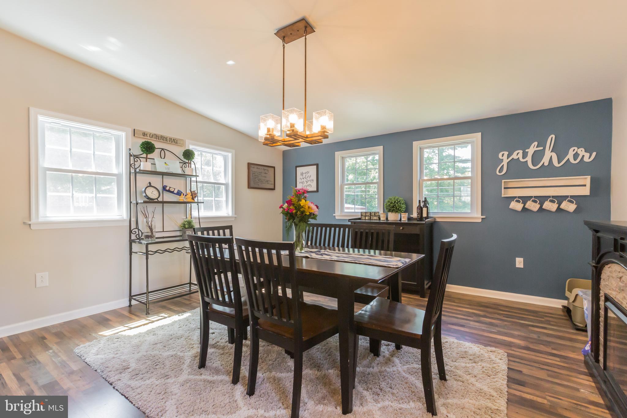 911 Scotia Road Philadelphia, PA 19128 - Photo 7 of 27 a dining room with furniture a chandelier and wooden floor