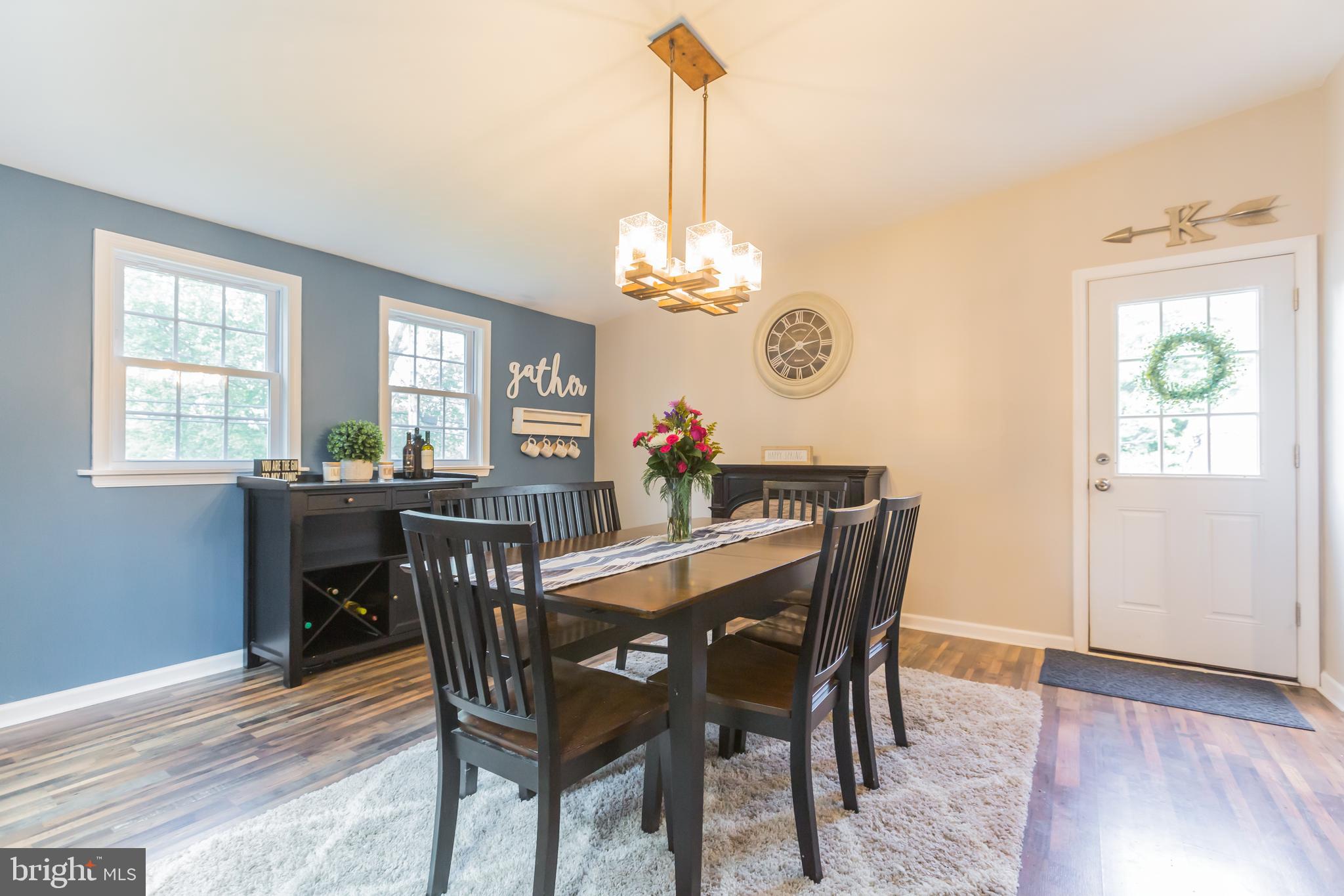 911 Scotia Road Philadelphia, PA 19128 - Photo 8 of 27 a dining room with furniture a chandelier and wooden floor