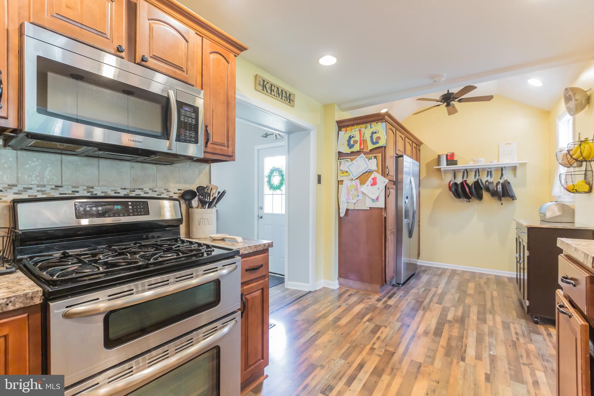 911 Scotia Road Philadelphia, PA 19128 - Photo 9 of 27 a kitchen with stainless steel appliances granite countertop a stove and a microwave