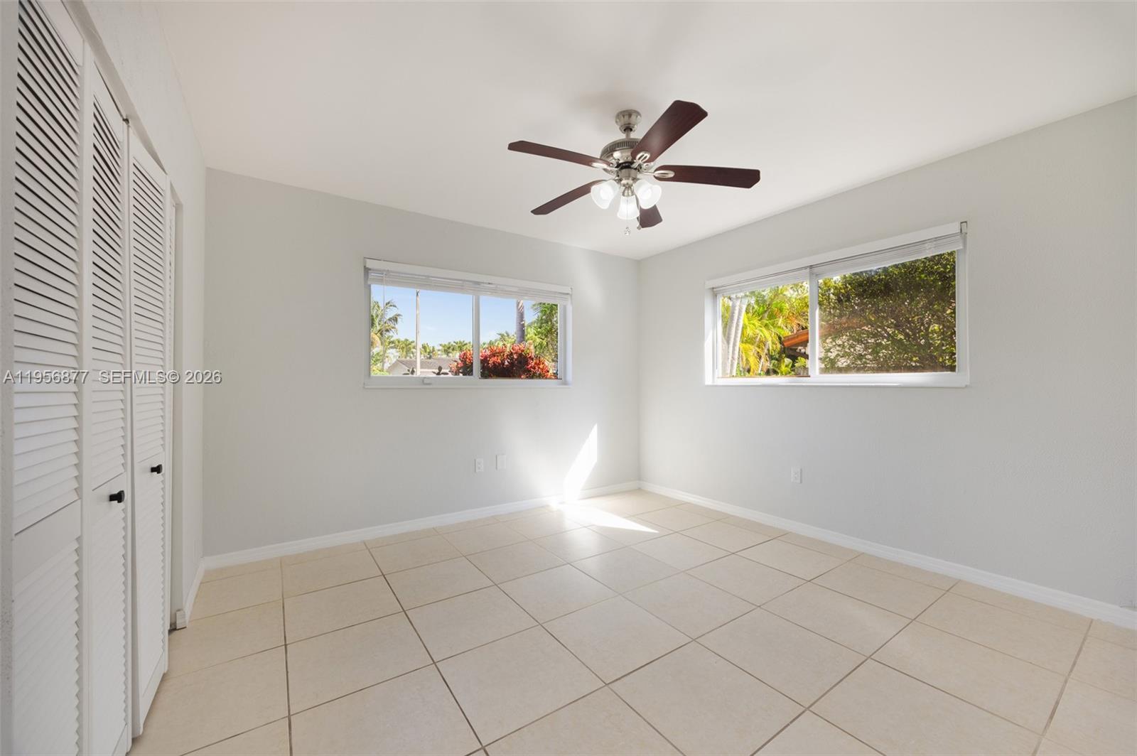 5730 Southwest 56th Terrace Miami, FL 33143 - Photo 11 of 18 a view of empty room with wooden floor and window