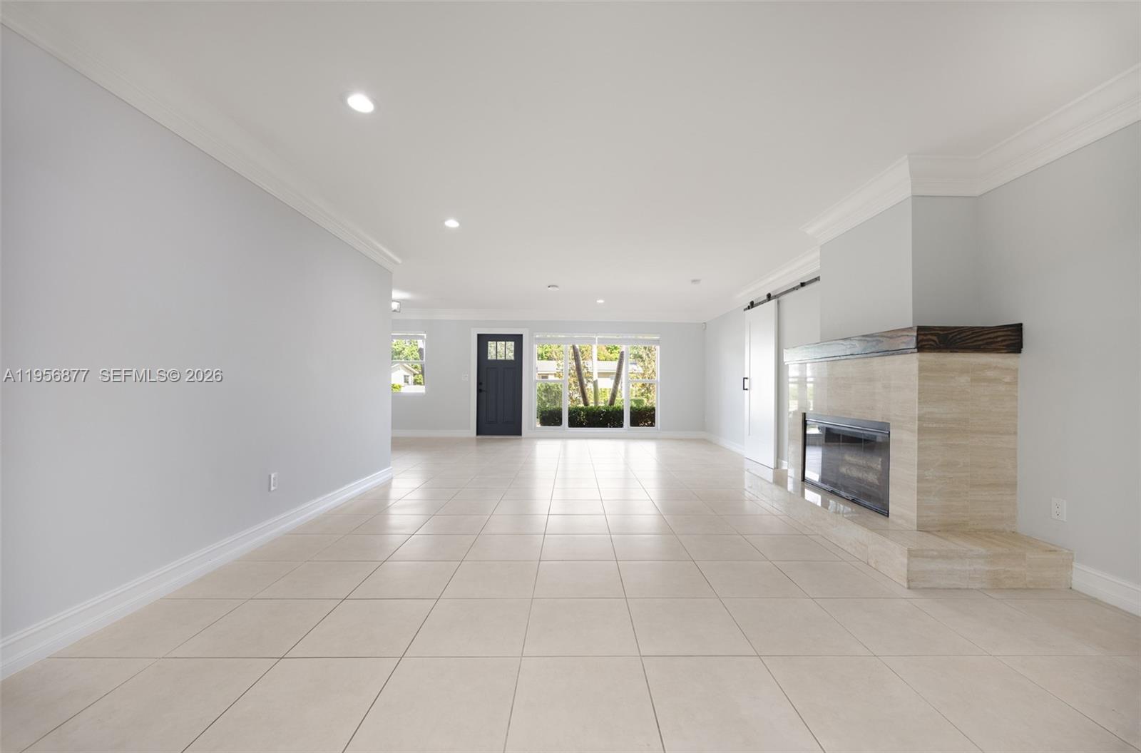 5730 Southwest 56th Terrace Miami, FL 33143 - Photo 4 of 18 a view of an empty room with a fireplace and a window